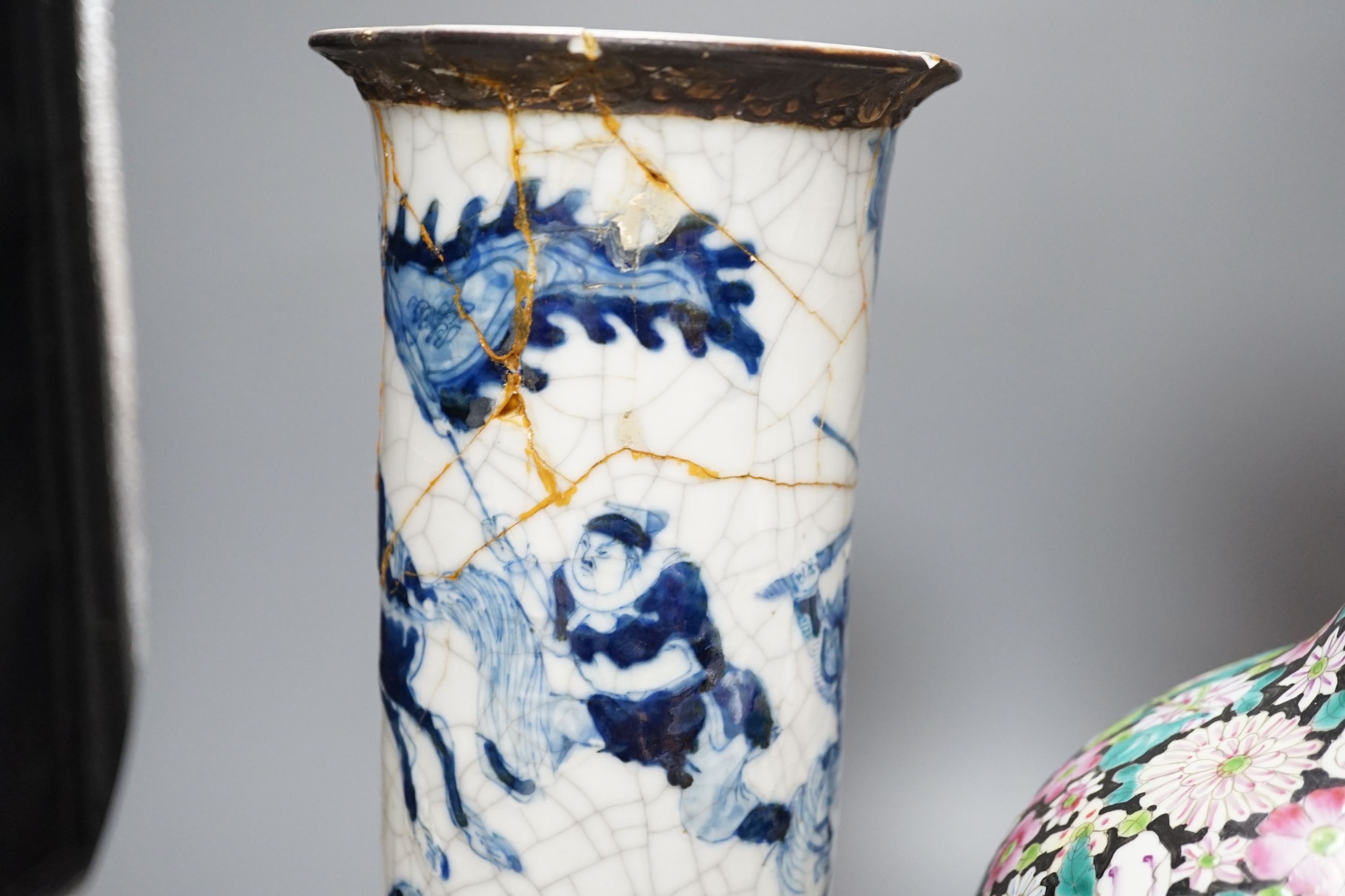 An early 20th century Chinese famille rose thousand flowers bottle vase (restored) together with a Chinese blue and white crackle glazed sleeve vase (a.f)., tallest 40cm